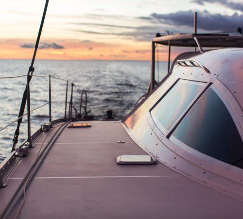 Sailing ship luxury yacht boat in the Sea during amazing sunset.